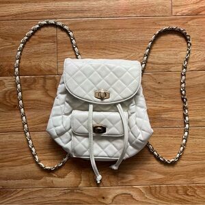 Small White Quilted Backpack with Chain Straps and Drawstring Closure